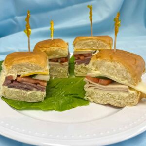 4 finger sandwiches with roast beef and cheddar, turkey and provolone or ham and swiss, tomato, lettuce, cucumbers or pickles on Hawaiian sweet rolls.
