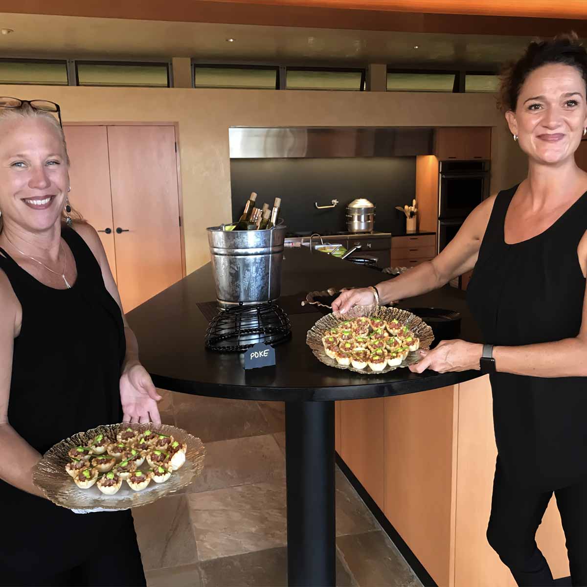 2 servers with Phyllo meat pies on serving trays